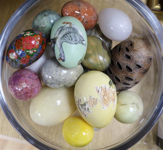 A quantity of eggs in a glass pedestal vase